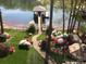 Well-manicured backyard with a walkway leading to a boat dock on the water at 2498 Smith Harbour Dr, Denver, NC 28037