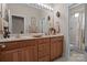 Bathroom with double vanity, decorative mirrors and lighting, and separate tub/shower at 2498 Smith Harbour Dr, Denver, NC 28037
