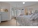 Bedroom featuring hardwood style floors, a four-poster bed, and a sunny sitting area at 2498 Smith Harbour Dr, Denver, NC 28037