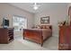 Bedroom with a window, dark wood furniture, and neutral paint at 2498 Smith Harbour Dr, Denver, NC 28037