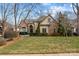 Charming home featuring a manicured lawn, stone accents, and mature trees, creating a welcoming curb appeal at 2498 Smith Harbour Dr, Denver, NC 28037