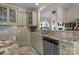Updated kitchen with granite countertops, mosaic backsplash, stainless steel appliances, and decorative glass cabinets at 2498 Smith Harbour Dr, Denver, NC 28037