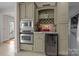 Kitchen with stainless steel appliances, including a microwave, oven, and wine cooler, and a built-in wine rack at 2498 Smith Harbour Dr, Denver, NC 28037
