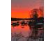 Beautiful fiery sunset over the lake with boat docks reflecting in the calm water at 2498 Smith Harbour Dr, Denver, NC 28037