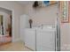 Laundry room with washer, dryer, storage cabinet, and ironing board at 2498 Smith Harbour Dr, Denver, NC 28037