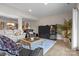 Spacious basement living room with hardwood style flooring, comfortable seating, and entertainment center at 2498 Smith Harbour Dr, Denver, NC 28037