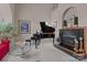 Elegant living room featuring a grand piano, fireplace, and comfortable seating with ample natural light at 2498 Smith Harbour Dr, Denver, NC 28037