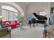 Inviting living room showcasing a grand piano, fireplace, and abundant natural light from large windows at 2498 Smith Harbour Dr, Denver, NC 28037