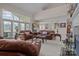 Open-concept living area with comfortable seating, a fireplace, and large windows overlooking the water at 2498 Smith Harbour Dr, Denver, NC 28037