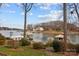 Scenic waterfront view featuring a dock, calm water, and several lakefront houses at 2498 Smith Harbour Dr, Denver, NC 28037