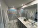 Modern bathroom featuring a double sink vanity, marble tile, and a glass-enclosed shower at 276 Laura Elizabeth Ln, Clover, SC 29710