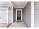 Inviting front entryway featuring a decorative wreath on the wood door and neutral siding at 3041 Winged Teal Ct, Belmont, NC 28012