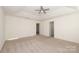 Spacious bedroom with ceiling fan and plush carpeting at 3139 Pinehills Way, Mount Holly, NC 28120