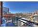 Balcony features metal railings and furniture overlooking community and colorful mural and skyline views at 3205 N Davidson St # 206, Charlotte, NC 28205