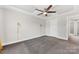 Primary bedroom with gray carpet, ceiling fan and en-suite bathroom at 3273 Bending Birch Pl, Charlotte, NC 28206