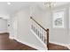 Bright entryway features a staircase with wood handrail, grey carpet and natural light from a window at 3273 Bending Birch Pl, Charlotte, NC 28206