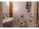 Bright bathroom featuring a pedestal sink, updated fixtures, and a window for natural light at 3581 Thompson St, Newton, NC 28658