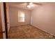 Well-lit bedroom featuring neutral walls, carpet flooring, and a large window with blinds at 3581 Thompson St, Newton, NC 28658