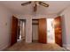 Neutral bedroom featuring a ceiling fan, closet, and ensuite bathroom at 3581 Thompson St, Newton, NC 28658