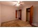 Bedroom with a ceiling fan, closet, and paneled doors, perfect for a cozy retreat at 3581 Thompson St, Newton, NC 28658