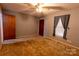 Comfortable bedroom with a ceiling fan, window with curtains, and closet door at 3581 Thompson St, Newton, NC 28658