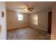 Spacious bedroom with carpet, ceiling fan, and ample natural light through two windows at 3581 Thompson St, Newton, NC 28658