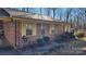 Brick ranch house with yellow shutters, front porch, and landscaping at 3581 Thompson St, Newton, NC 28658