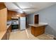 Kitchen features wood cabinets, laminate countertops and flooring at 3581 Thompson St, Newton, NC 28658