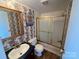 Bathroom with floral wallpaper, bathtub, and sink at 3610 Becky Ln, Monroe, NC 28112