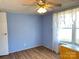 Bedroom with light blue walls, wood flooring, and window at 3610 Becky Ln, Monroe, NC 28112
