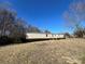 Mobile home with a well-maintained yard and hedge at 3610 Becky Ln, Monroe, NC 28112