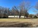 Mobile home with yard and trees in the background at 3610 Becky Ln, Monroe, NC 28112