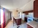 Eat-in kitchen with island, appliances, and dark wood cabinets at 3610 Becky Ln, Monroe, NC 28112