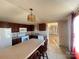 Eat-in kitchen with island, appliances, and dark wood cabinets at 3610 Becky Ln, Monroe, NC 28112