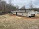 Rear view of manufactured home, showing a deck and storage building at 372 Forest Hollow Dr, Statesville, NC 28677