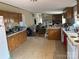 A modest kitchen featuring wood cabinets and an electric stove at 372 Forest Hollow Dr, Statesville, NC 28677