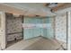 A basement kitchenette with wallpaper and blue painted cabinets at 40503 Millingport Rd, Richfield, NC 28137