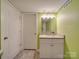 Basement bathroom with granite vanity, updated fixtures, and green walls at 4539 Sapp Rd, Kannapolis, NC 28083