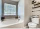 Bathroom featuring a bathtub, toilet, and shelving at 5113 Park Place Dr, Dallas, NC 28034