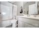 Bathroom with white vanity, shower, and striped curtain at 5113 Park Place Dr, Dallas, NC 28034