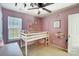 Charming bedroom with a twin bed, dresser, and pink walls at 5113 Park Place Dr, Dallas, NC 28034