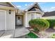 Inviting front entry with a glass door and neatly trimmed shrubs at 5113 Park Place Dr, Dallas, NC 28034