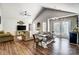 Open living room with vaulted ceiling, hardwood floors, and a farmhouse table at 5113 Park Place Dr, Dallas, NC 28034