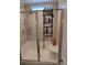 Clean and well-organized shower with a built-in seat, adjustable shower head, and sliding glass doors at 5122 Wrenn Dr, Denver, NC 28037