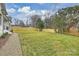 Large backyard with a well maintained lawn and a wooden fence at 5300 Lansing Dr, Charlotte, NC 28270