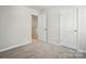 Neutral bedroom with gray carpet, open closet and white doors at 604 Cassidy Ct, Clover, SC 29710