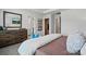 Bedroom featuring a wooden dresser, soft carpet, and blue decorative pillows at 604 Cassidy Ct, Clover, SC 29710
