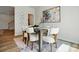 Formal dining area with wooden table and white chairs, illuminated by natural light and stylish decor at 604 Cassidy Ct, Clover, SC 29710