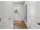 Hallway with hardwood floors, white walls, and a clear view of the front door at 604 Cassidy Ct, Clover, SC 29710