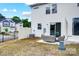 Back exterior of house with patio set and partial fence and grass at 604 Cassidy Ct, Clover, SC 29710